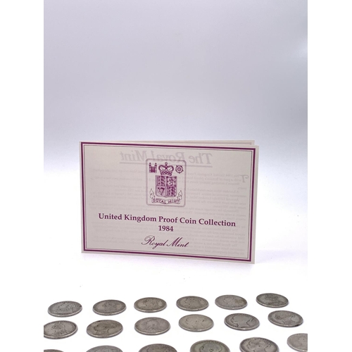 2260 - A collection of coins to include approx. 160g of British 92.5% silver shillings, cased 1984 Royal Mi... 