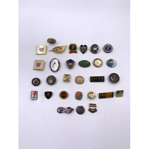 2267 - A collection of vintage enamel badges to include GMB, United Road Transport Workers etc.