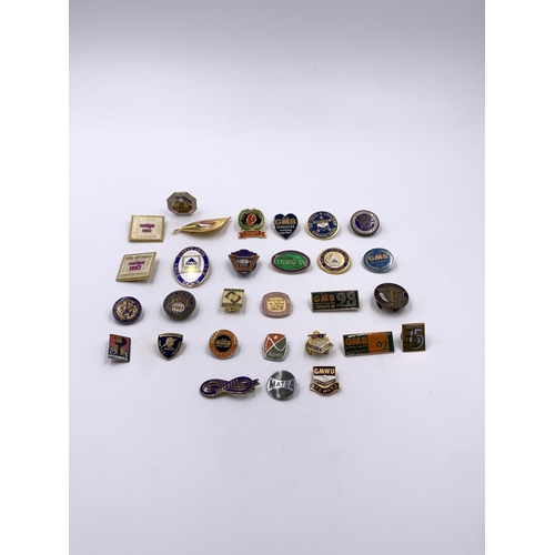 2267 - A collection of vintage enamel badges to include GMB, United Road Transport Workers etc.