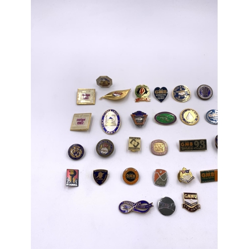 2267 - A collection of vintage enamel badges to include GMB, United Road Transport Workers etc.