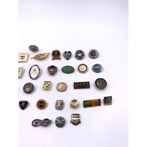 2267 - A collection of vintage enamel badges to include GMB, United Road Transport Workers etc.