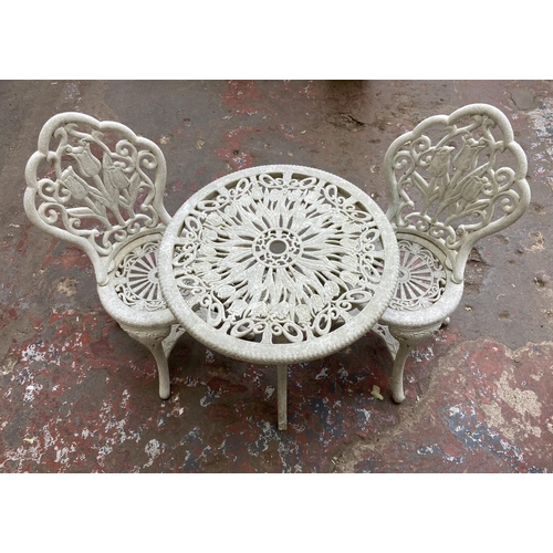 111 - A Victorian style plastic three piece patio set - table approx. 66cm high x 67cm diameter