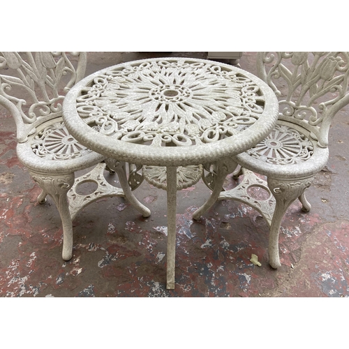 111 - A Victorian style plastic three piece patio set - table approx. 66cm high x 67cm diameter