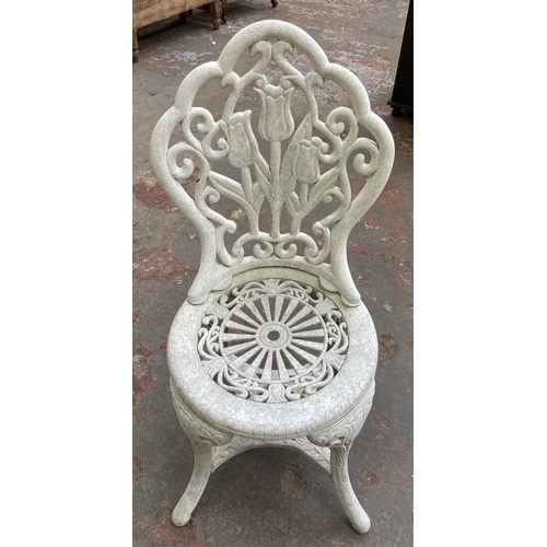 111 - A Victorian style plastic three piece patio set - table approx. 66cm high x 67cm diameter