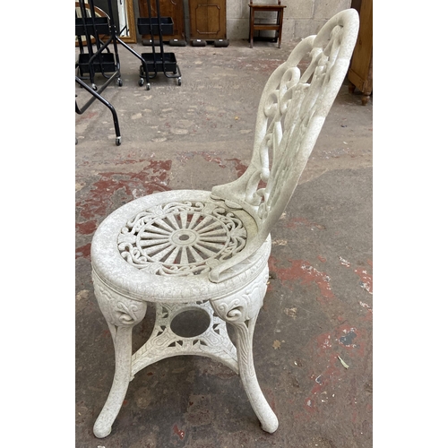 111 - A Victorian style plastic three piece patio set - table approx. 66cm high x 67cm diameter