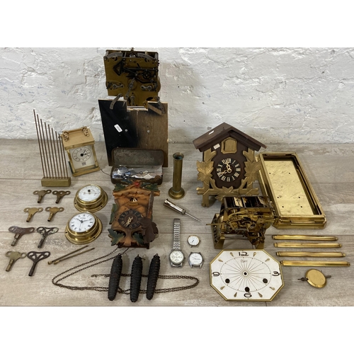 132 - A collection of clock and watch spares and accessories to include Metamec brass cased carriage clock... 