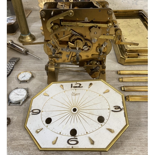 132 - A collection of clock and watch spares and accessories to include Metamec brass cased carriage clock... 