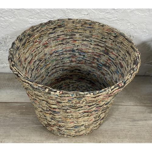 142 - Two handmade woven newspaper waste paper bins - largest approx. 33cm high x 43cm diameter