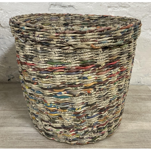 142 - Two handmade woven newspaper waste paper bins - largest approx. 33cm high x 43cm diameter