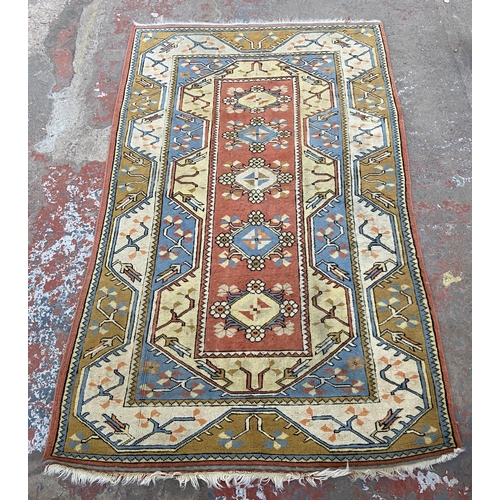 151 - A vintage machine woven multi-coloured rug