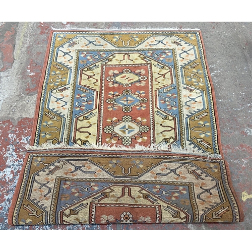 151 - A vintage machine woven multi-coloured rug