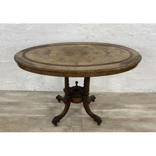 156 - A Victorian walnut and mahogany oval hall table on quatrefoil pedestal base - approx. 67cm high x 98... 