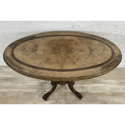 156 - A Victorian walnut and mahogany oval hall table on quatrefoil pedestal base - approx. 67cm high x 98... 