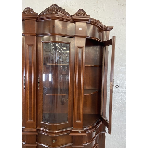 179 - An Italian style inlaid mahogany bow fronted display cabinet with three lower cupboard doors, three ... 