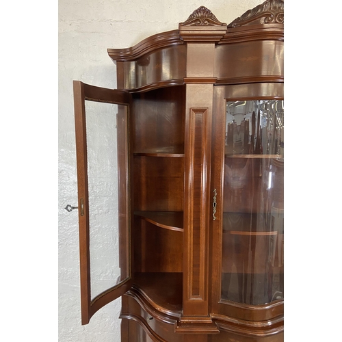 179 - An Italian style inlaid mahogany bow fronted display cabinet with three lower cupboard doors, three ... 