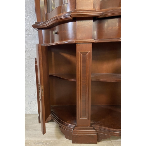 179 - An Italian style inlaid mahogany bow fronted display cabinet with three lower cupboard doors, three ... 