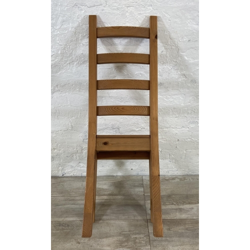 180 - A set of four pine ladderback dining chairs