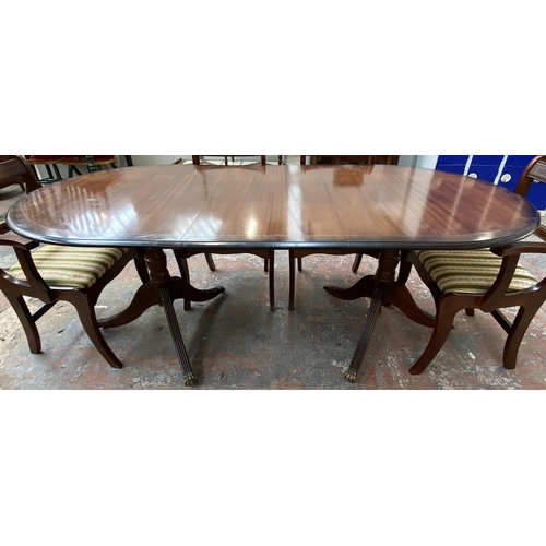 181 - A Regency style mahogany twin pedestal extending dining table with four dining chairs and two carver... 