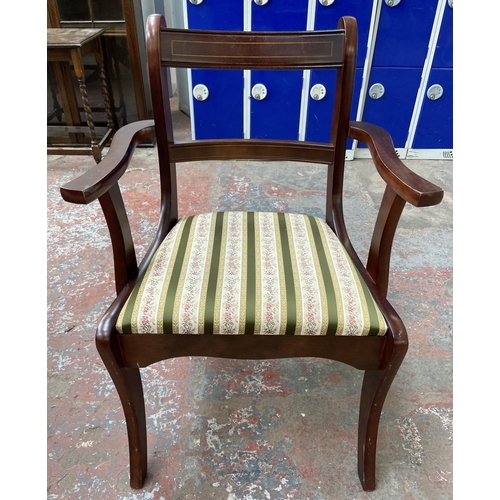 181 - A Regency style mahogany twin pedestal extending dining table with four dining chairs and two carver... 