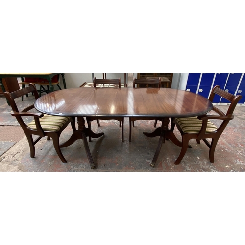 181 - A Regency style mahogany twin pedestal extending dining table with four dining chairs and two carver... 