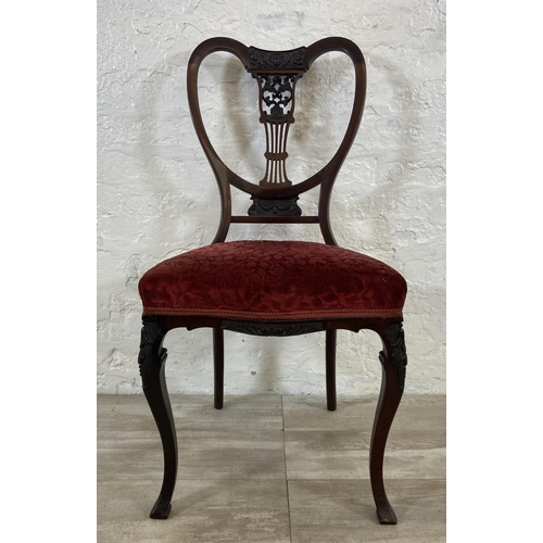 200 - A set of four Edwardian mahogany dining chairs with carved detailed backs and cabriole supports