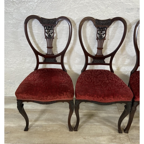 200 - A set of four Edwardian mahogany dining chairs with carved detailed backs and cabriole supports