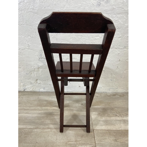 25 - A late 19th/early 20th century oak folding child's chair - approx. 66cm high