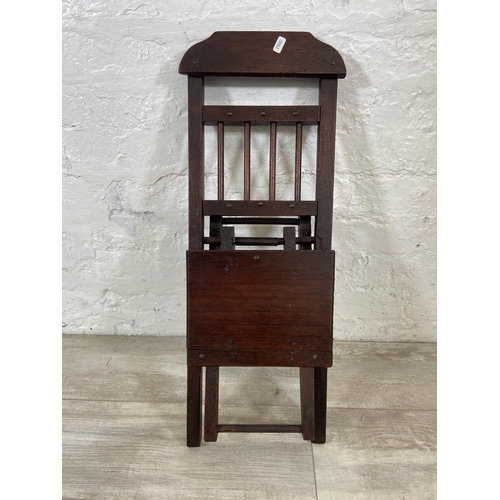 25 - A late 19th/early 20th century oak folding child's chair - approx. 66cm high