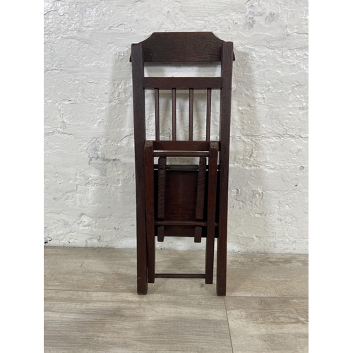 25 - A late 19th/early 20th century oak folding child's chair - approx. 66cm high