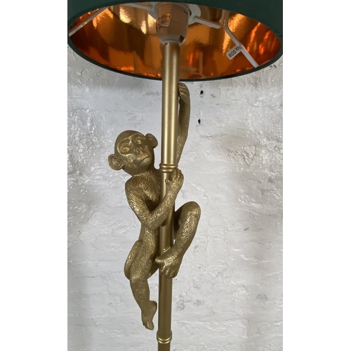 29 - A gilt metal hanging monkey figural standard lamp - approx. 150cm high