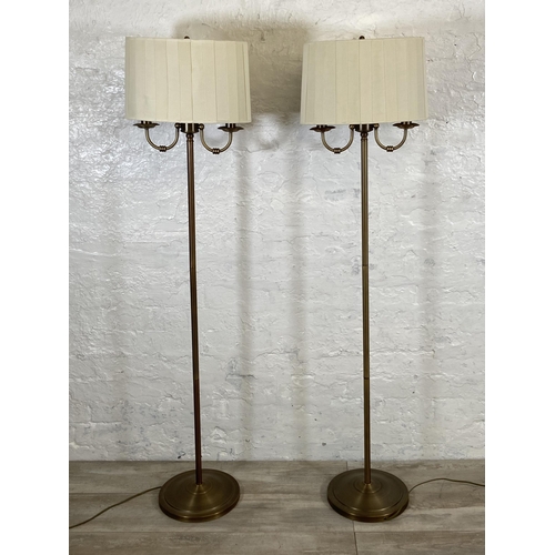 39 - A pair of B&Q Ripley 2L gilt metal two branch floor lamps - approx. 143cm high