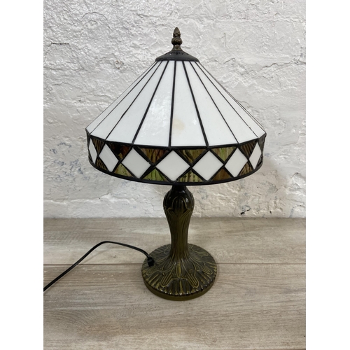 40 - A Tiffany style bronzed metal and stained glass table lamp - approx. 47cm high