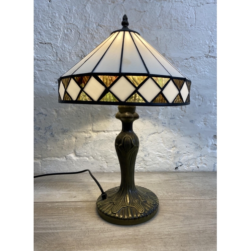 40 - A Tiffany style bronzed metal and stained glass table lamp - approx. 47cm high