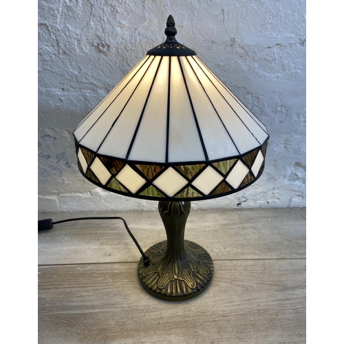 40 - A Tiffany style bronzed metal and stained glass table lamp - approx. 47cm high