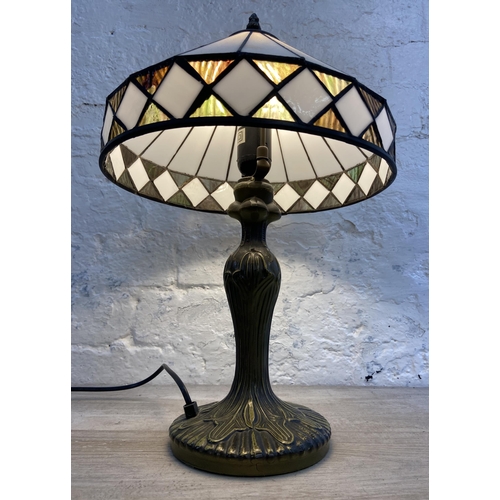 40 - A Tiffany style bronzed metal and stained glass table lamp - approx. 47cm high