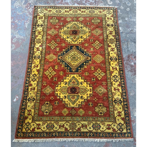 5 - A machine woven multi-coloured floral pattern rug - approx. 215cm x 140cm