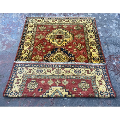 5 - A machine woven multi-coloured floral pattern rug - approx. 215cm x 140cm