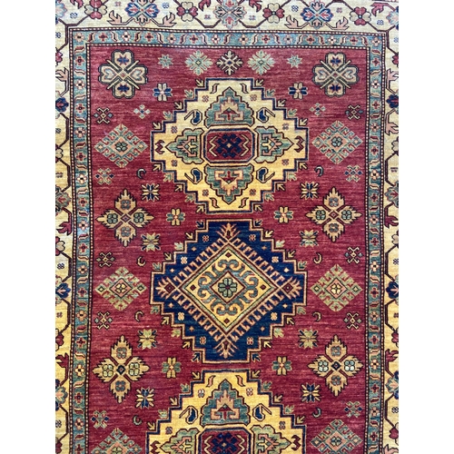 5 - A machine woven multi-coloured floral pattern rug - approx. 215cm x 140cm