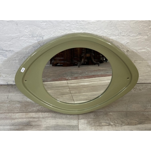 56 - A mid 20th century green glazed ceramic framed wall mirror - approx. 50cm high x 63cm wide