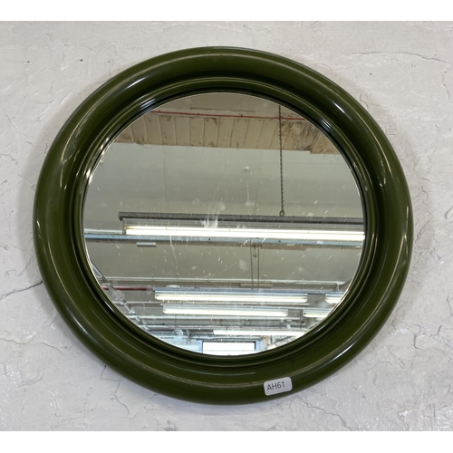 57 - A mid 20th century green plastic framed circular wall mirror - approx. 40cm diameter