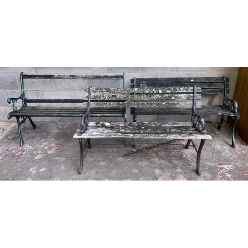 104 - Three cast metal and wooden slatted garden benches