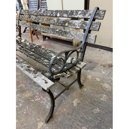 104 - Three cast metal and wooden slatted garden benches