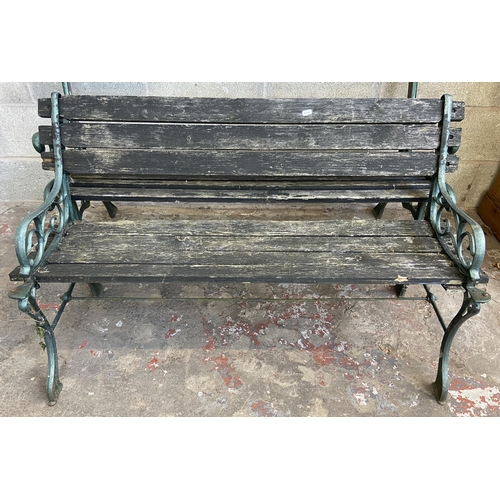 104 - Three cast metal and wooden slatted garden benches