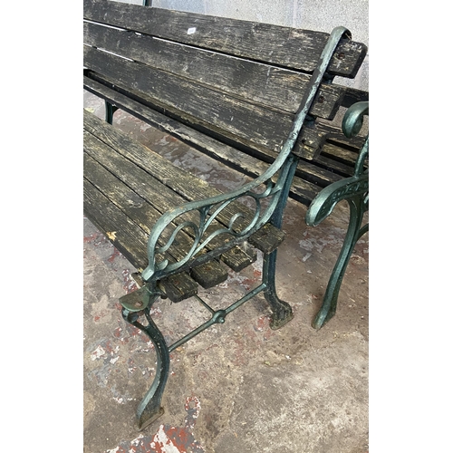 104 - Three cast metal and wooden slatted garden benches