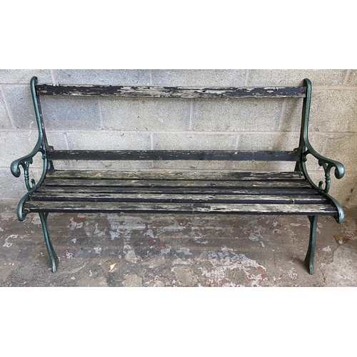 104 - Three cast metal and wooden slatted garden benches