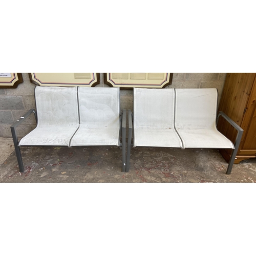 105 - A pair of grey metal and white plastic two seater garden benches