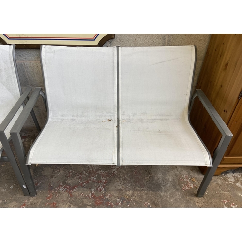 105 - A pair of grey metal and white plastic two seater garden benches