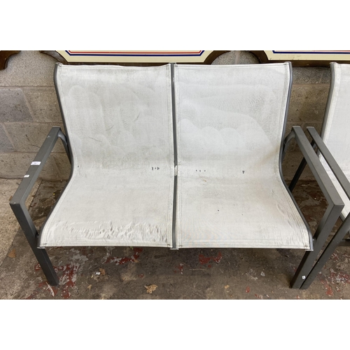 105 - A pair of grey metal and white plastic two seater garden benches