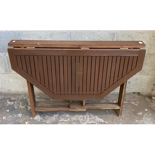 106 - A teak octagonal drop leaf gate leg garden table