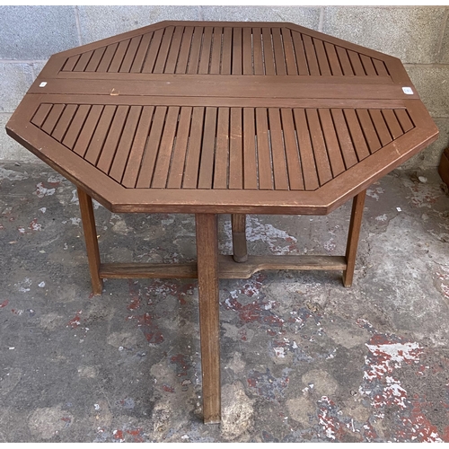 106 - A teak octagonal drop leaf gate leg garden table